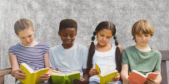 Four kids reading a book